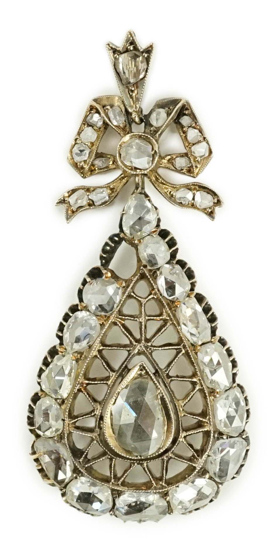 An early 19th century gold and rose cut diamond cluster set pear shaped drop pendant, with ribbon bow bale